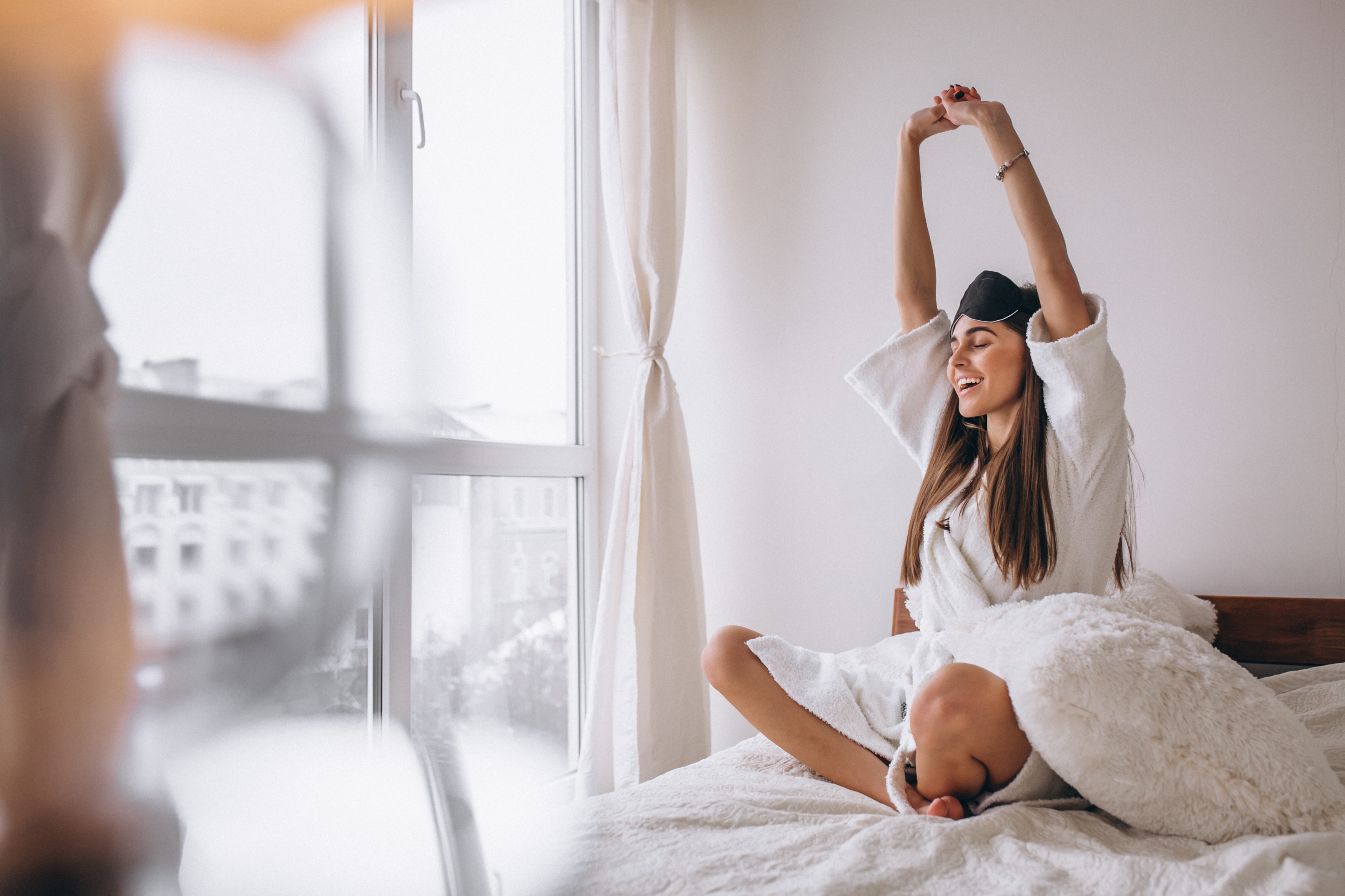 Woman bed wearing sleeping mask